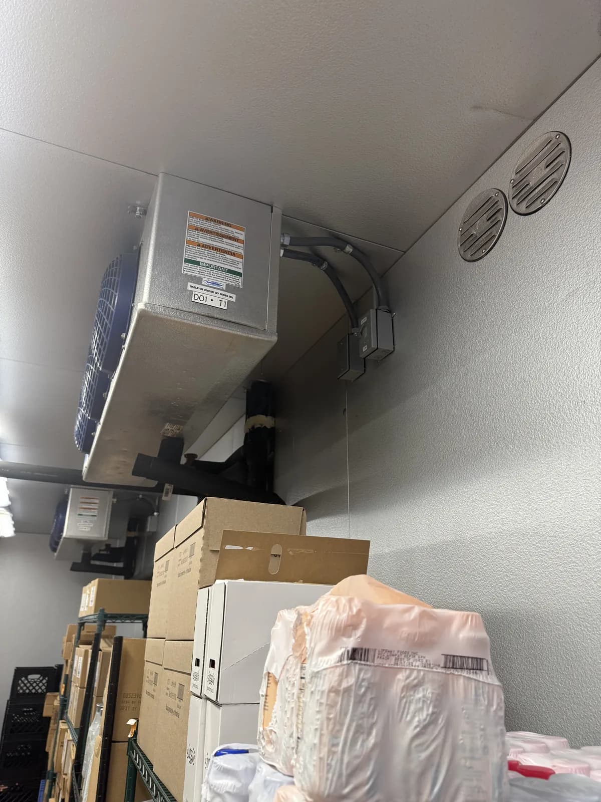 Walk-in cooler evaporator over stored product in a South Florida commercial kitchen serviced by Vice Mechanical